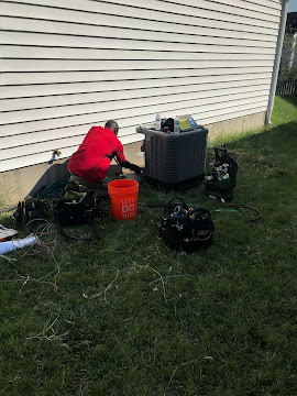 Outdoor AC repair and servicing at residential home in Fox Lake, MO.