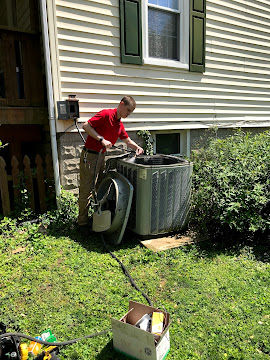 Outdoor AC repair service at residential home in Overland, MO.
